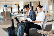 Business Travellers Waiting For Their Flight At Airport