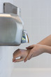 Drying hands in a public restroom (selective focus)