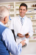 © Monkey Business - American pharmacist with senior man in pharmacy