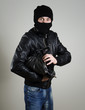 © M-Production - Portrait of scared male burglar with a handbag.