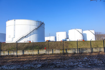 white tank in tank farm with blue sky