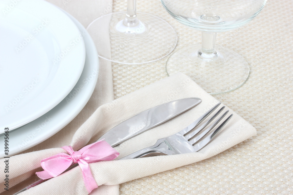 Table setting with fork, knife, plates, and napkin