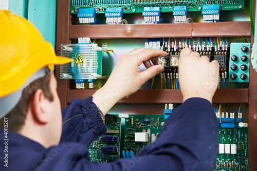 Fotografia, Obraz Electrician at safety fuse device replace work