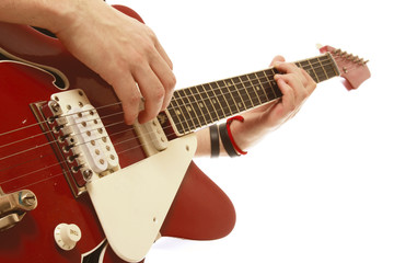 Close-up of a guitar and playing hands, isolated on white