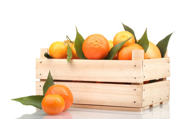 Wall Mural - Ripe tasty tangerines with leaves in wooden box isolated