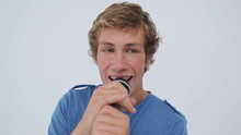 Happy Young Man Singing With A Microphone