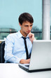 © Milles Studio - A young man sitting in front of a laptop at office