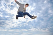 Young man jumping for joy in the air