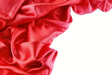 Red silk material on white background. Copy space