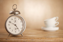 5 O'clock Tea Time, Retro Alarm And White Tea Cups On Background