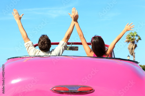 Fototapeta na wymiar Freedom - happy free couple in car