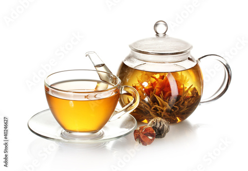 Fototapeta na wymiar exotic green tea with flowers in glass teapot and cup isolated