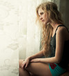 © VectorART - beautiful blonde sitting near a window