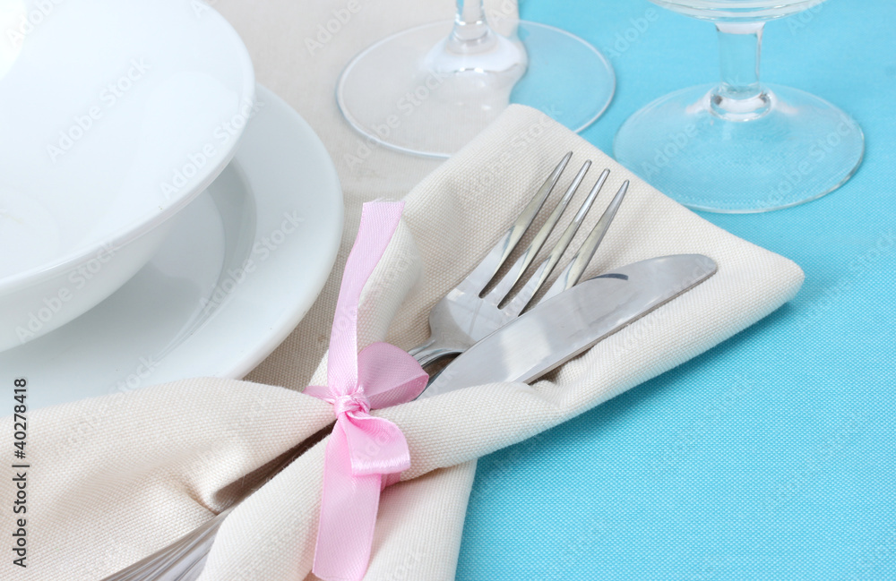 Table setting with fork, knife, plates, and napkin