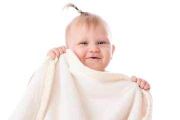 adorable baby playing with white blanket