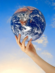 Wall Mural - Planet earth in finger.Elements of this image furnished by NASA