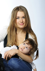 small beautiful girl in jeans and vest with ma