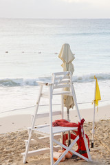 Wall Mural - Lifeguard Stand on Beach with Yellow Caution Flag