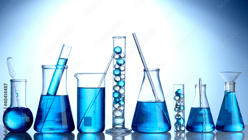 Test-tubes with blue liquid on blue background