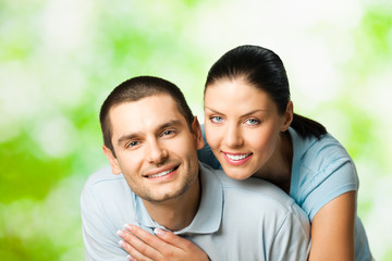 Portrait of young smiling couple, outdoors