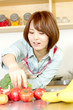 © one - Beautiful young woman in kitchen making salad