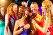 © Kzenon - Party people dancing in disco or club