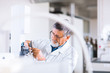 © lightpoet - senior male researcher carrying out scientific research in a lab