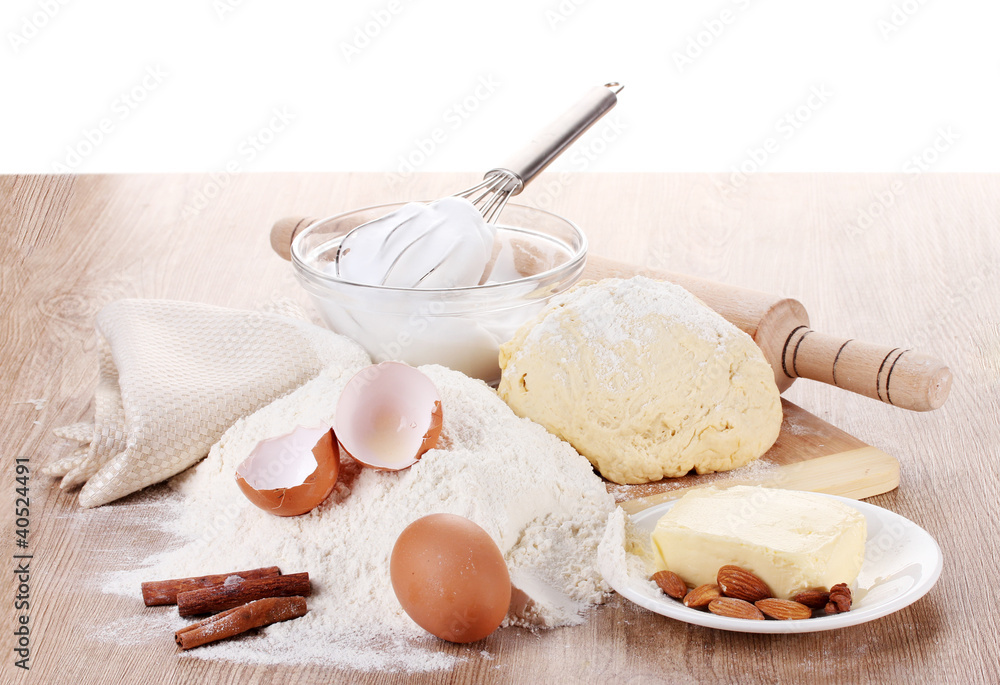Ingredients for the dough wooden table on white background