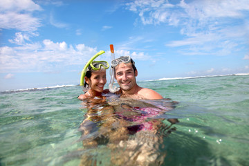 Portrait of happy couple doing snorkeling