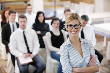 Wall Mural - business woman standing with her staff at conference