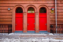 Three Red Door On Building Exterior