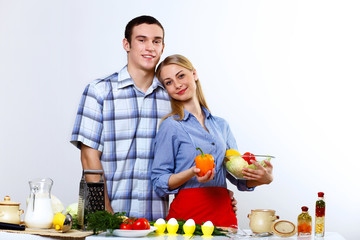 Husband and wife together coooking at home