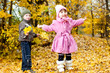 © Hyrma - Little boy and girl play in a park in autumn