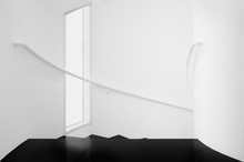 Spiral Staircases Between White Walls And Black Floor