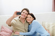 © Alliance - Smiling young couple making self photo