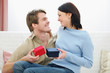 © Alliance - Romantic couple exchanging presents