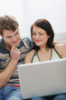 © Alliance - Young couple working on laptop