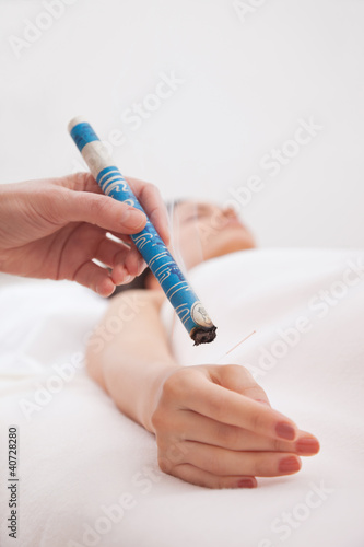 Fotografie, Obraz Hand applying moxa stick white background