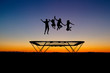 silhouette of kids on trampoline in sunset