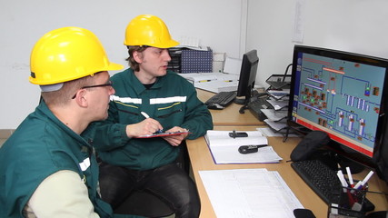 Wall Mural - Industrial workers in control room