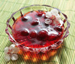 Cherry preserves in a saucer and flower