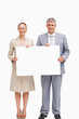 © WavebreakmediaMicro - Business people smiling while holding a poster