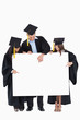 © WavebreakmediaMicro - Three graduates pointing to the blank sign