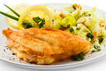 Fish dish - fried fish fillets and vegetable salad