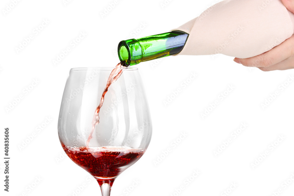 Pouring wine into wineglass isolated on white