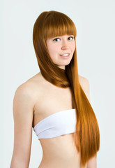  Beautiful young red-haired woman with long beauty straight hair.