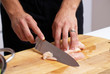 male hands slicing chicken
