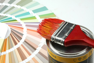 Close-up of a color palette, brush, paint on white background