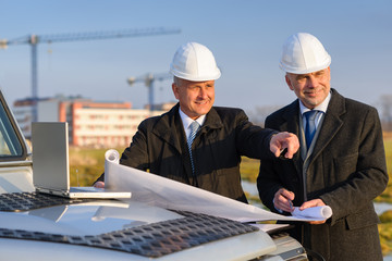 Architect developer point at construction site