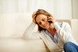© pablocalvog - Young woman enjoying conversation on mobile phone